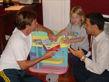 The doctor working with a girl and her father